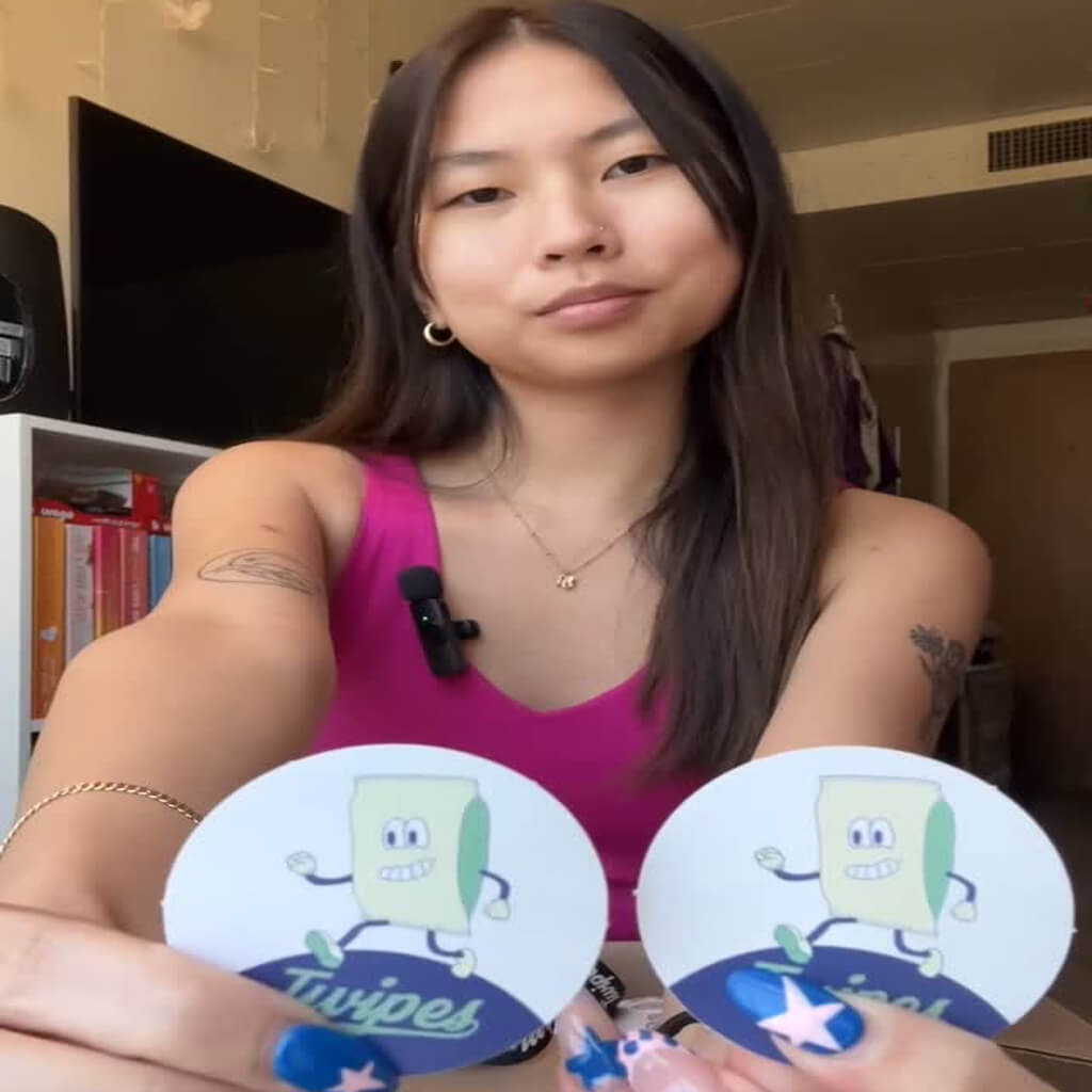 Karis Buffalo Influencer Instagram post Social media post of a woman holding two stickers of a cartoon of a pack of wet wipes