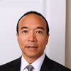 Edmund profile photo Headshot of a man in a black suit and tie