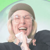 Jess profile photo A woman laughs while wiping her face with a wet wipe