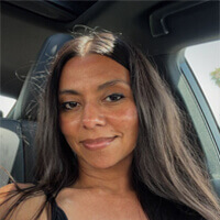 Laura profile photo Selfie of a woman in a car, smiling
