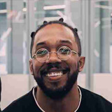 Mike profile photo A man smiles while sitting in an office